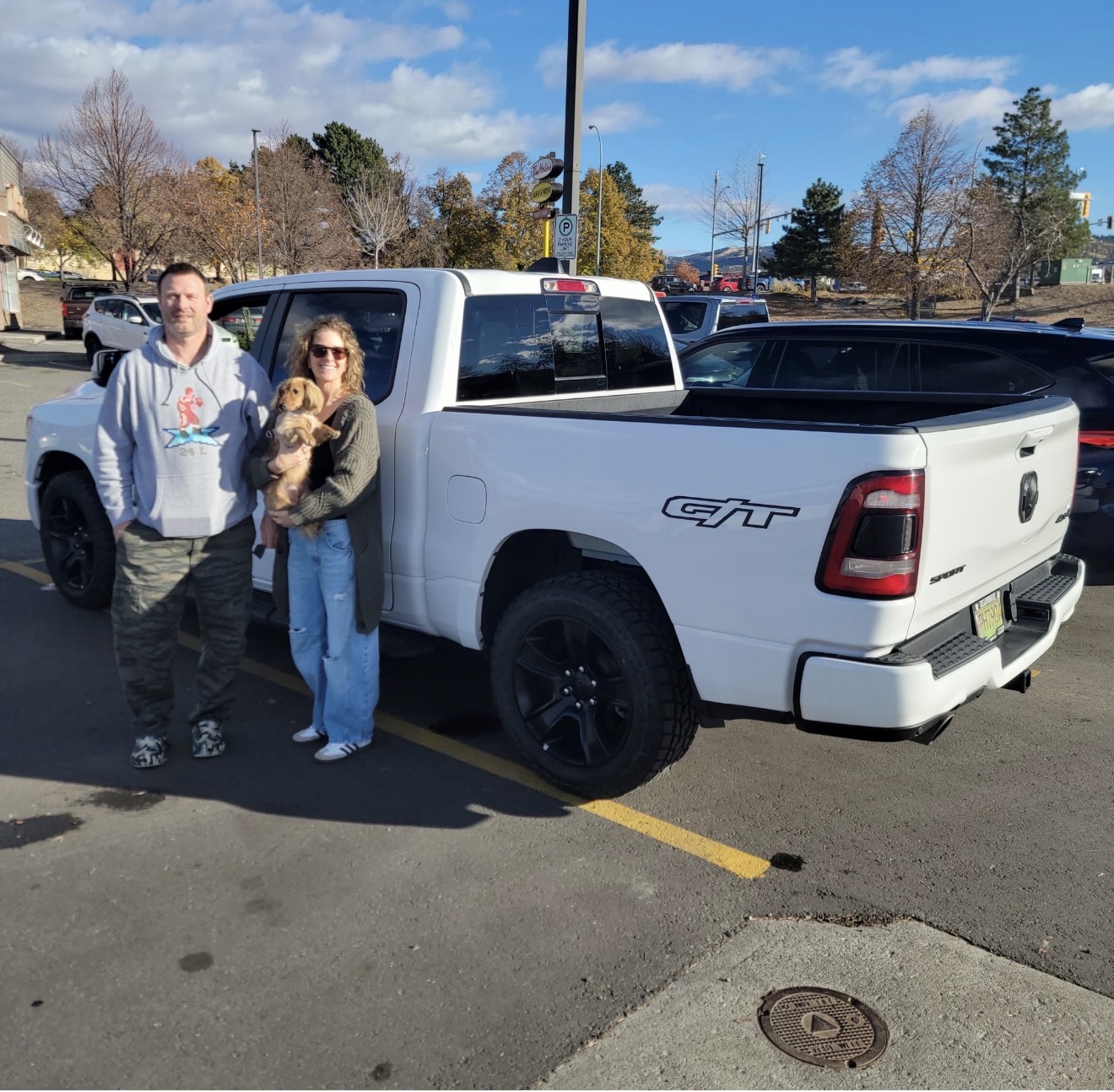 Couple with RAM 1500 Sport and puppy — Easy Ride Canada, Kelowna BC